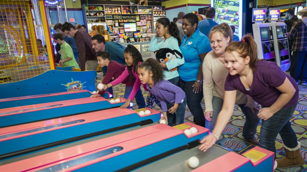 Families playing ski ball
