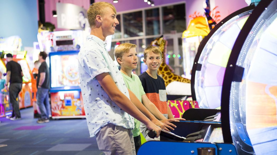 Family playing arcade games together