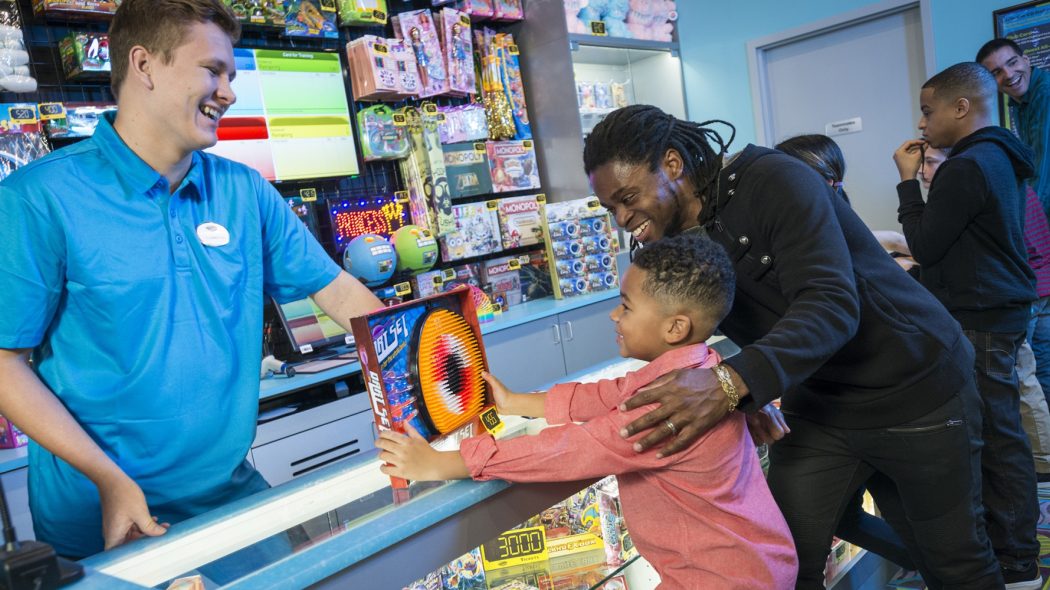 Child receiving a prize at arcade prize counter